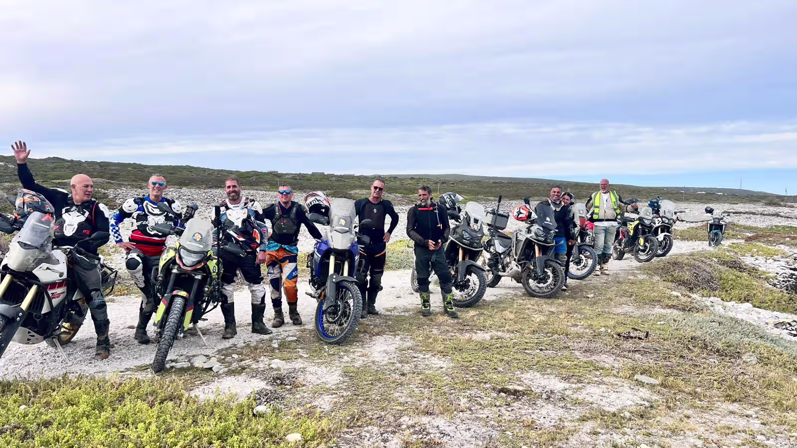 AMT riders in full riding gear at a gravel stop